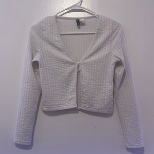 White long sleeve fitted v neck top with two bottons